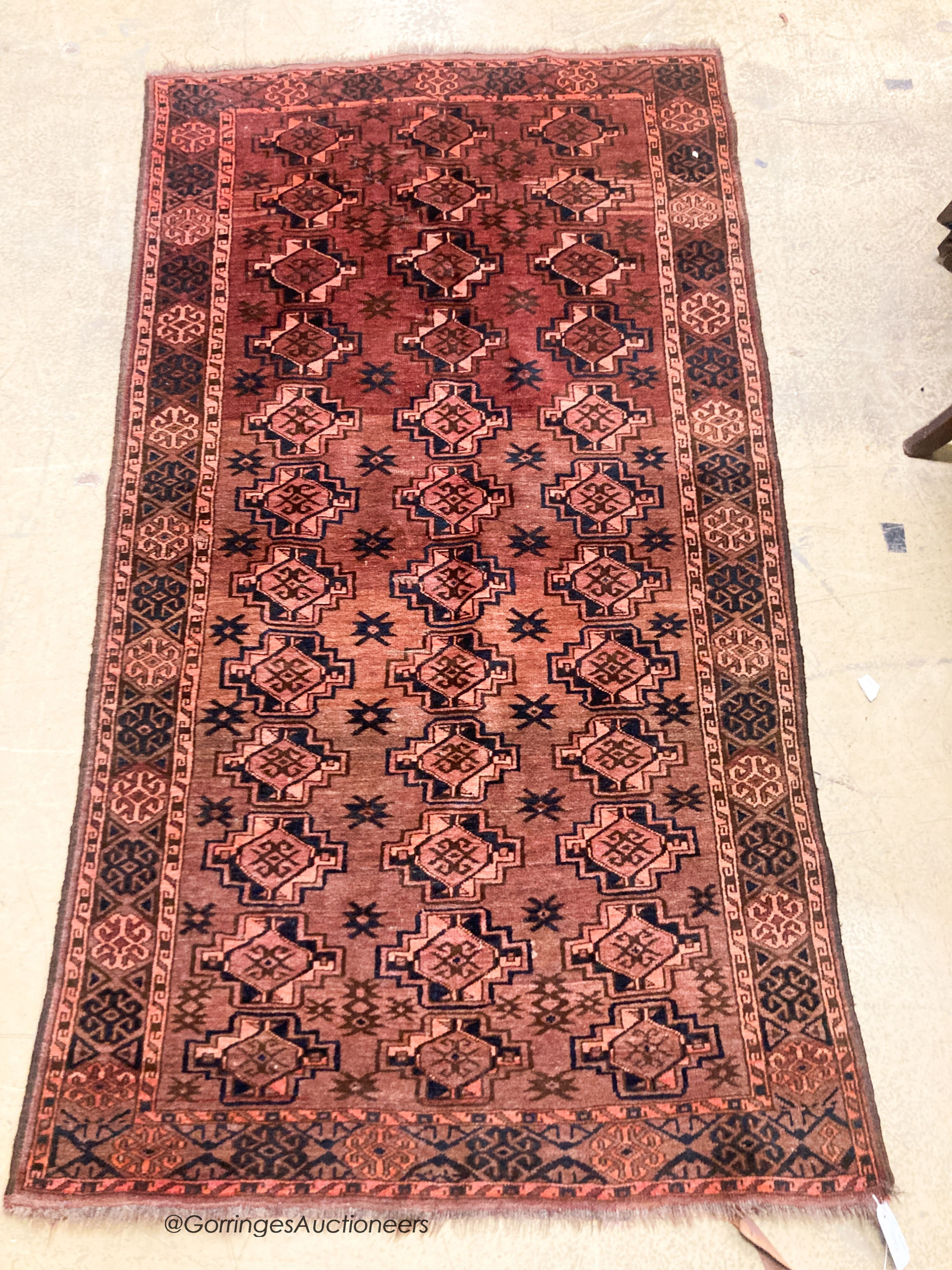 A Bokhara burgundy ground rug, 190 x 105cm